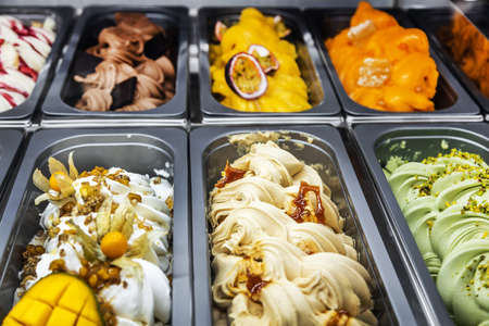 ice cream with different flavors, in trays in the refrigeratorの写真素材