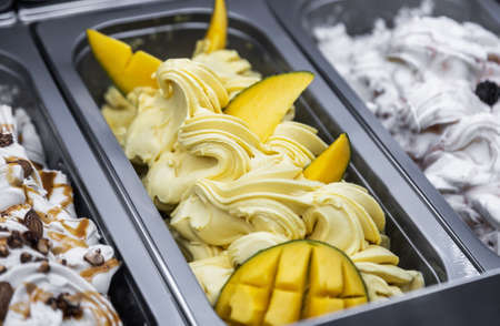 ice cream with different flavors, in trays in the refrigeratorの写真素材