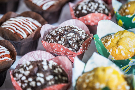 cupcakes and muffins with different flavors, fillings and different sprinklesの写真素材