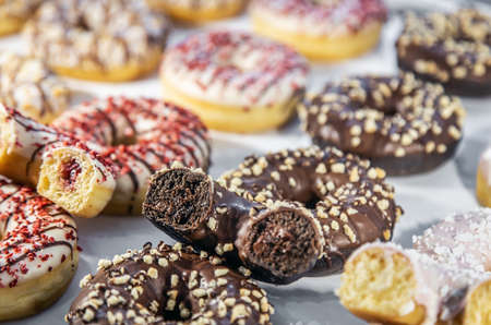donuts with different flavors, fillings and different sprinklesの写真素材