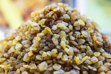raisins are heaped on the counter of a storeの写真素材