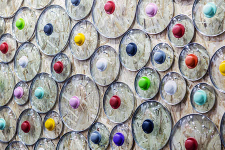glass lids from pots and pans on the store counterの写真素材
