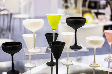 different colored glasses for drinks are on the shelvesの写真素材