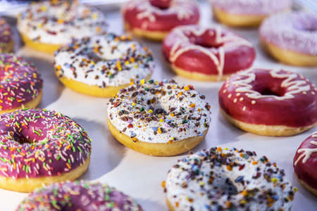 donuts with different flavors, fillings and different sprinklesの写真素材