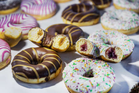 donuts with different flavors, fillings and different sprinklesの写真素材