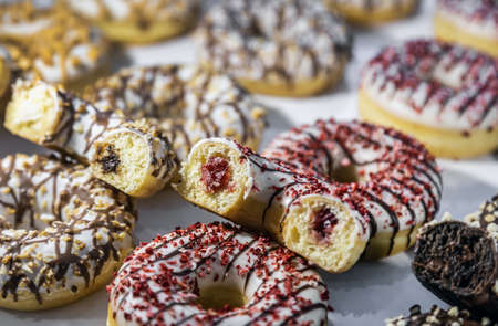 donuts with different flavors, fillings and different sprinklesの写真素材