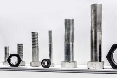 different size bolts with nuts are screwed as a sample