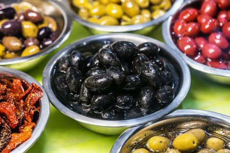 pickled olives with different fillings, pepper stuffed with cheeseの写真素材