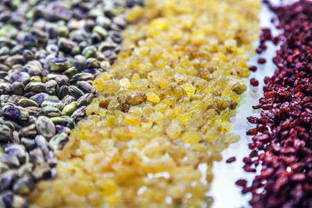 peeled pistachio nuts with raisins are on the store counterの写真素材