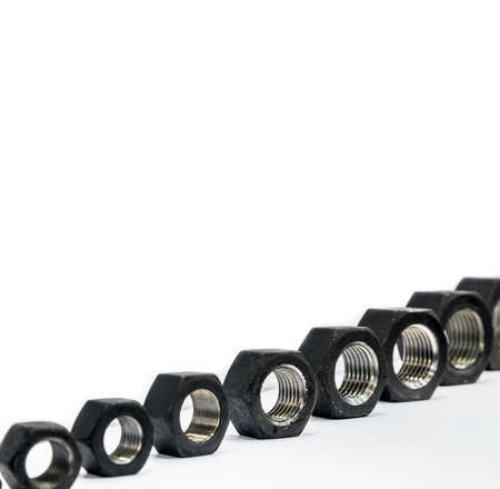 steel nuts of different diameters on a light background
