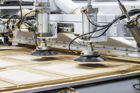 production of kitchen facades on a drilling and filler machine of furniture facadesの写真素材