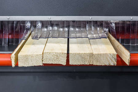 board is sawn on a wood-sawing machineの写真素材