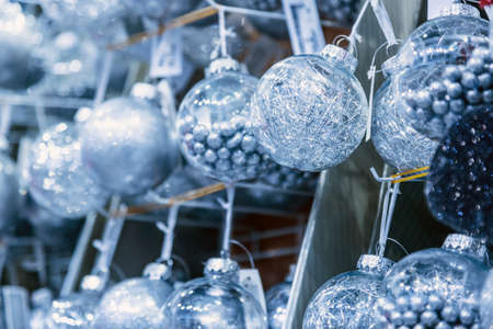 Christmas ball hangs on a shelf at a Christmas market or storeの写真素材