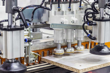 production of kitchen facades on a drilling and filler machine of furniture facadesの写真素材