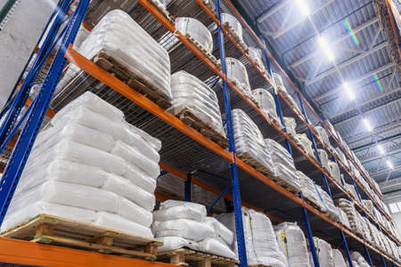 goods are on the shelves of a large warehouse of productsの写真素材