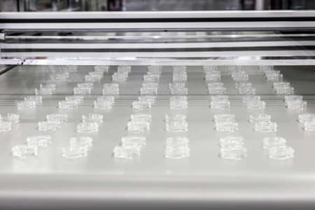 moving parts of the conveyor with plastic productsの写真素材