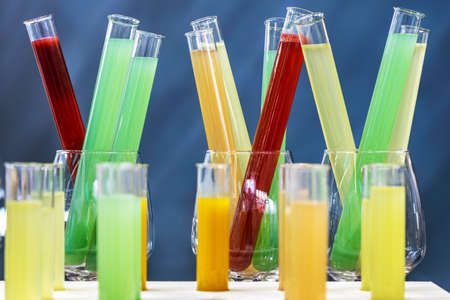 medical test tubes with liquids of different colors, juices, drinks or alcoholic cocktailsの写真素材