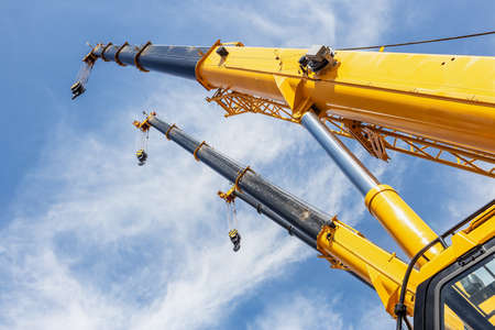 the long arrows of the construction car cargo craneの写真素材