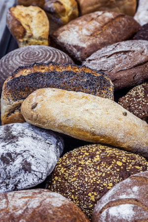 many different types of bread. Wholegrain, round, rolls and loavesの写真素材