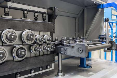 rollers at the machine for straightening the metal barの写真素材