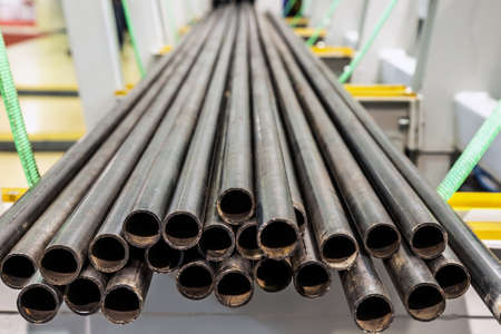 metal pipes are prepared for cutting on the machine. Focus on the ends of the pipes,