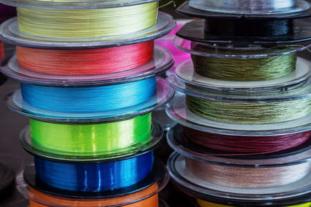 different types of fishing monofilament and braided cords in fishing reels.の写真素材