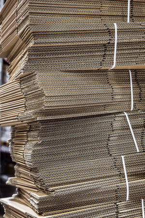 stacks of folded cardboard boxes in a warehouse or in a storeの写真素材