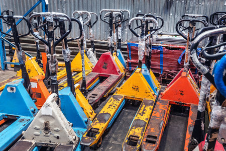 there are a lot of old hydraulic trolleys in stock. mechanical equipment for moving goods manuallyの写真素材
