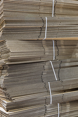 stacks of folded cardboard boxes in a warehouse or in a storeの写真素材