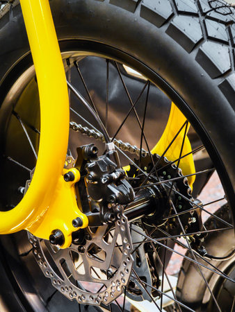 Close-up of a bright yellow bicycle wheel showcasing detailed mechanics and robust tire designの写真素材