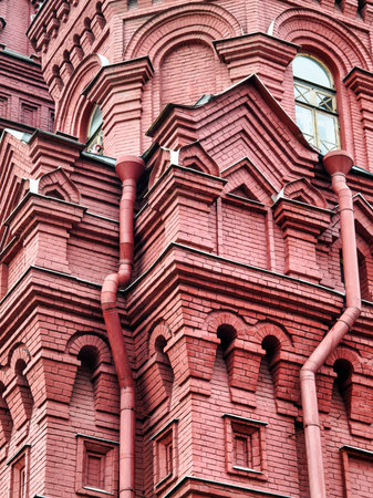 Detail of red brick architecture featuring intricate design elements in an iconic building under bright daylightの写真素材