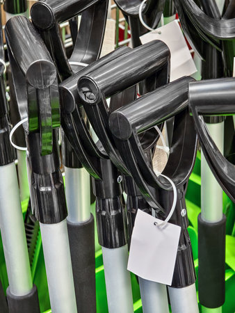 Collection of new gardening shovels displayed in a retail store during daylight hoursの写真素材