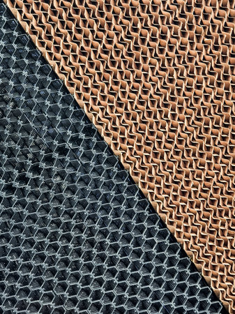 Industrial filter showcasing contrasting materials with intricate honeycomb patterns and textures in a manufacturing settingの写真素材
