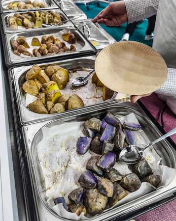Culinary display of various potato varieties at a food event held in a community hallの写真素材