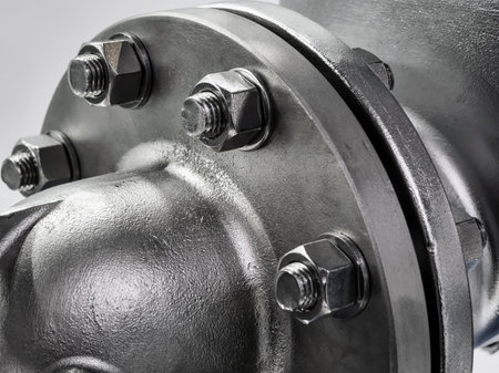 Close-up view of a steel flange with nuts and bolts showcasing industrial engineering precisionの写真素材