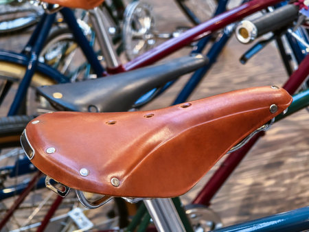 Bicycles lined up in a vibrant urban setting, showcasing a unique leather saddle design during daylight hoursの写真素材