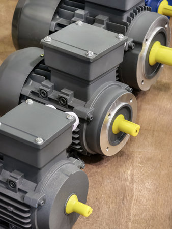 Electric motors lined up on a table showcasing industrial design and engineering in a workshop settingの写真素材