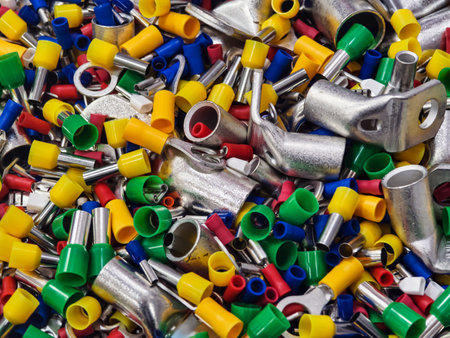 Colorful assortment of electrical connectors scattered on a surface in a workshop environmentの写真素材