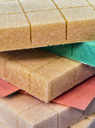 Close-up view of colorful foam rubber sheets stacked in layers for crafting and design projectsの写真素材