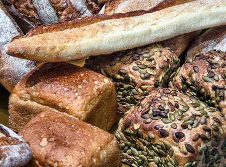 Freshly baked bread assortment on display at a bakery during morning hoursの写真素材