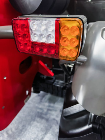 Detailed view of tractor tail light highlighting functionality and design in agricultural settingの写真素材