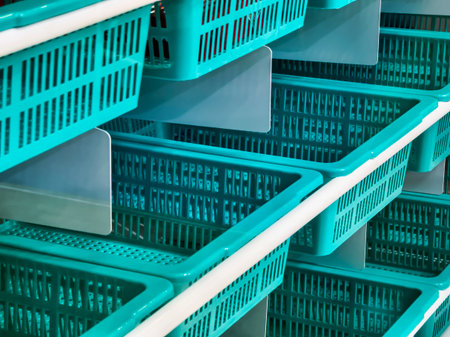 Shopping baskets neatly arranged in a store aisle, ready for customers to use during their shopping...