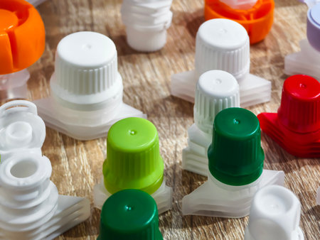Various plastic bottle caps displayed on a wooden surface highlighting color and design diversity