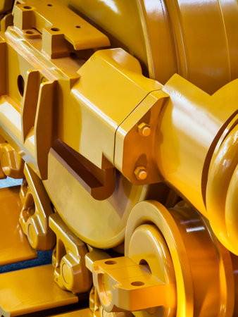 Close-up view of heavy machinery components in vivid yellow color showcasing industrial design and engineering detailsの写真素材