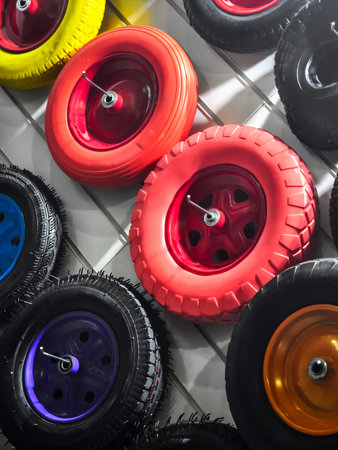 Colorful display of various wheels and tires mounted on a wall in a creative arrangementの写真素材