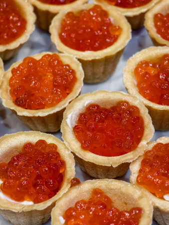 salmon caviar in tartlets, laid out on a tableの写真素材