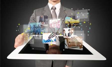 Tablet, man, meadow.の写真素材