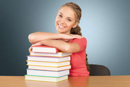 Young female college student and stack of bookの写真素材