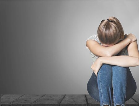 Young woman crying on backgroundの写真素材