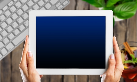 Woman holding digital tablet in the cafe.